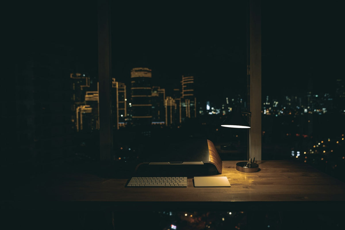 A warm desk lamp glowing in the dark — the real late-night study session