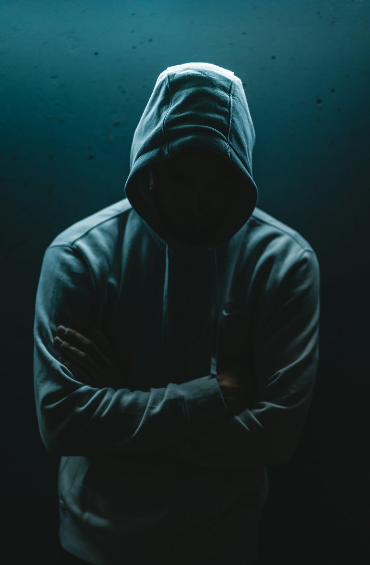 Person in a dark oversized hoodie, styled and considered