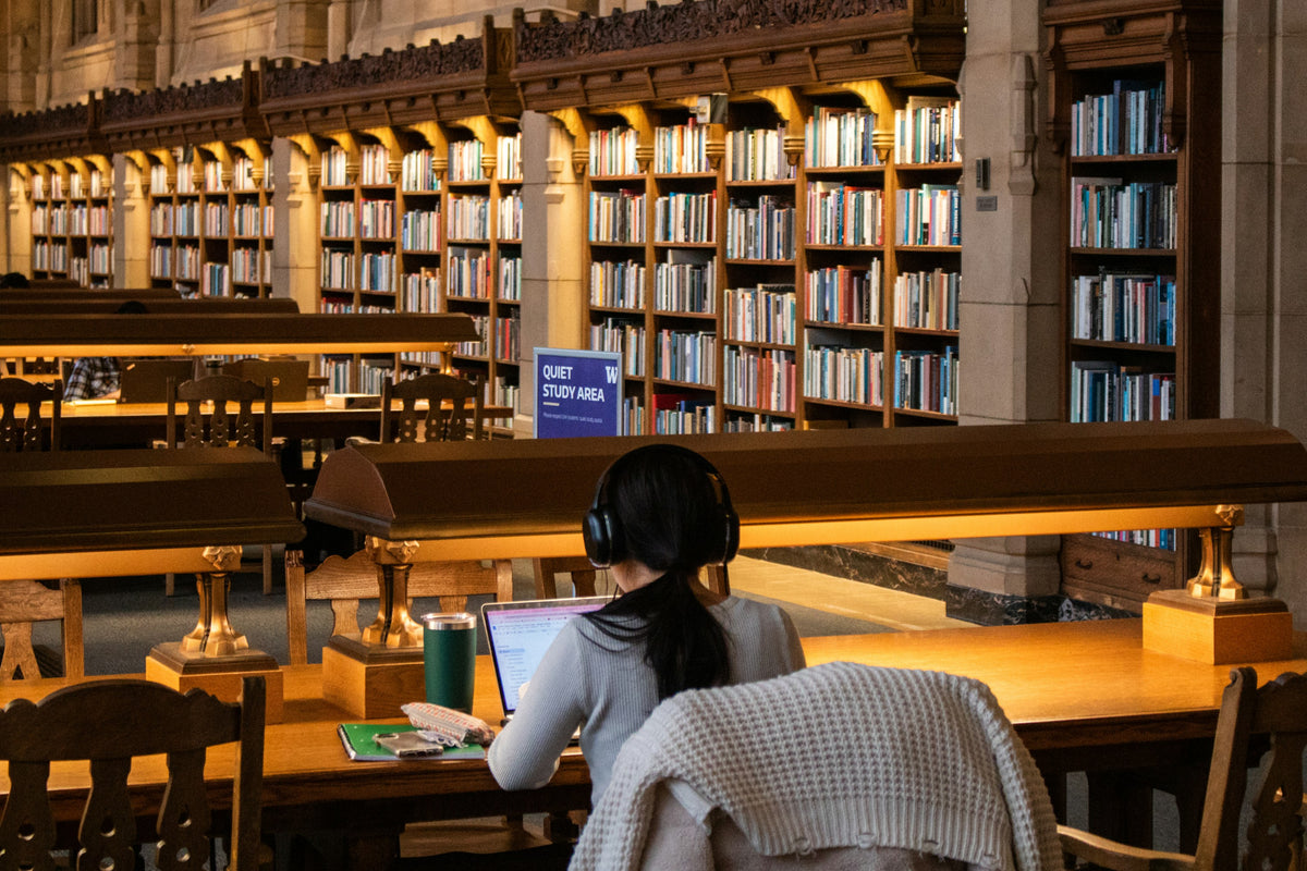 Student studying alone in a grand university library