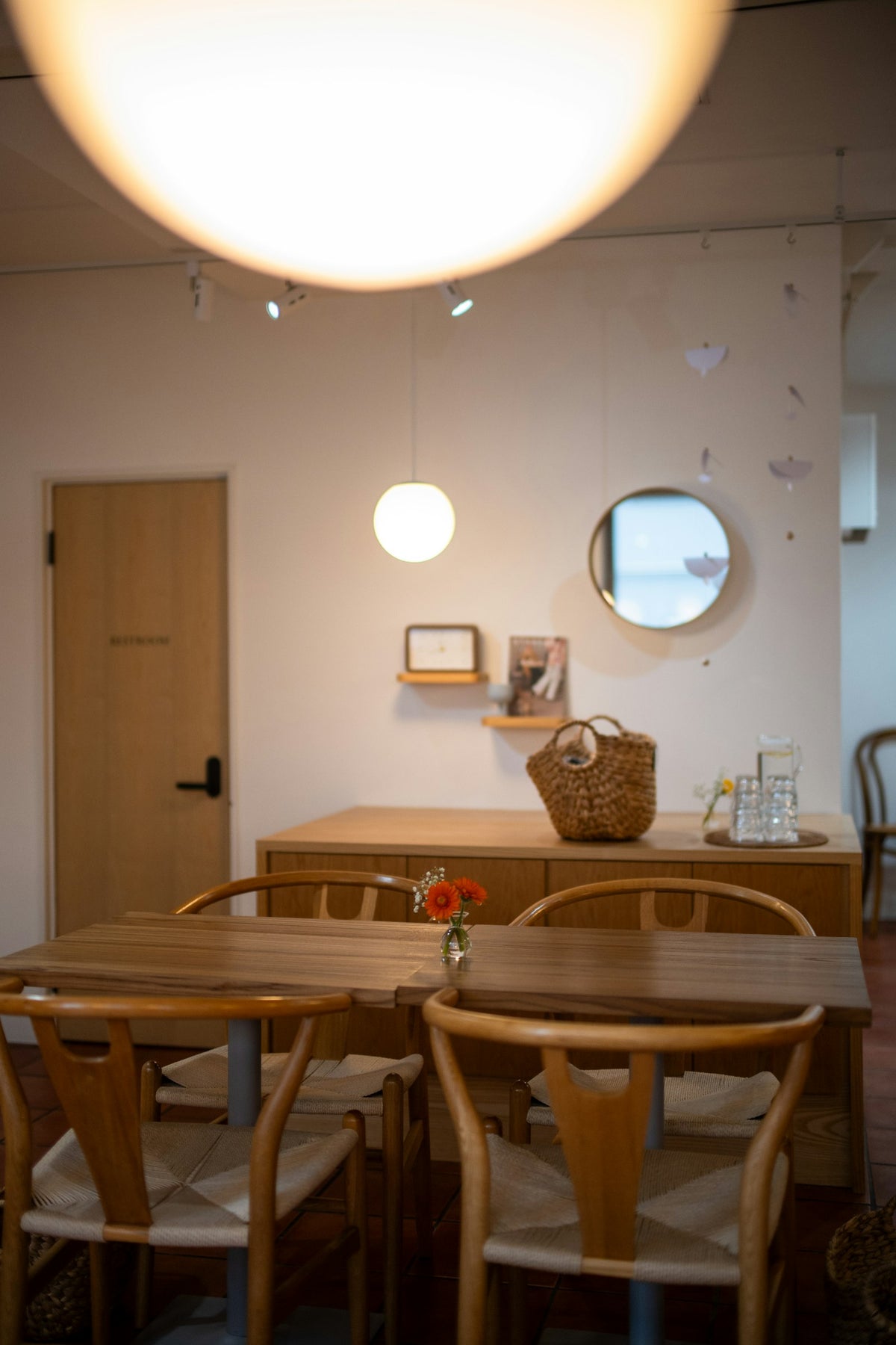 A cozy cafe interior with warm lighting, wooden tables, and empty chairs waiting for the next study session