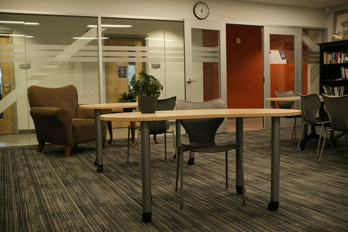 An empty library study room in low evening light