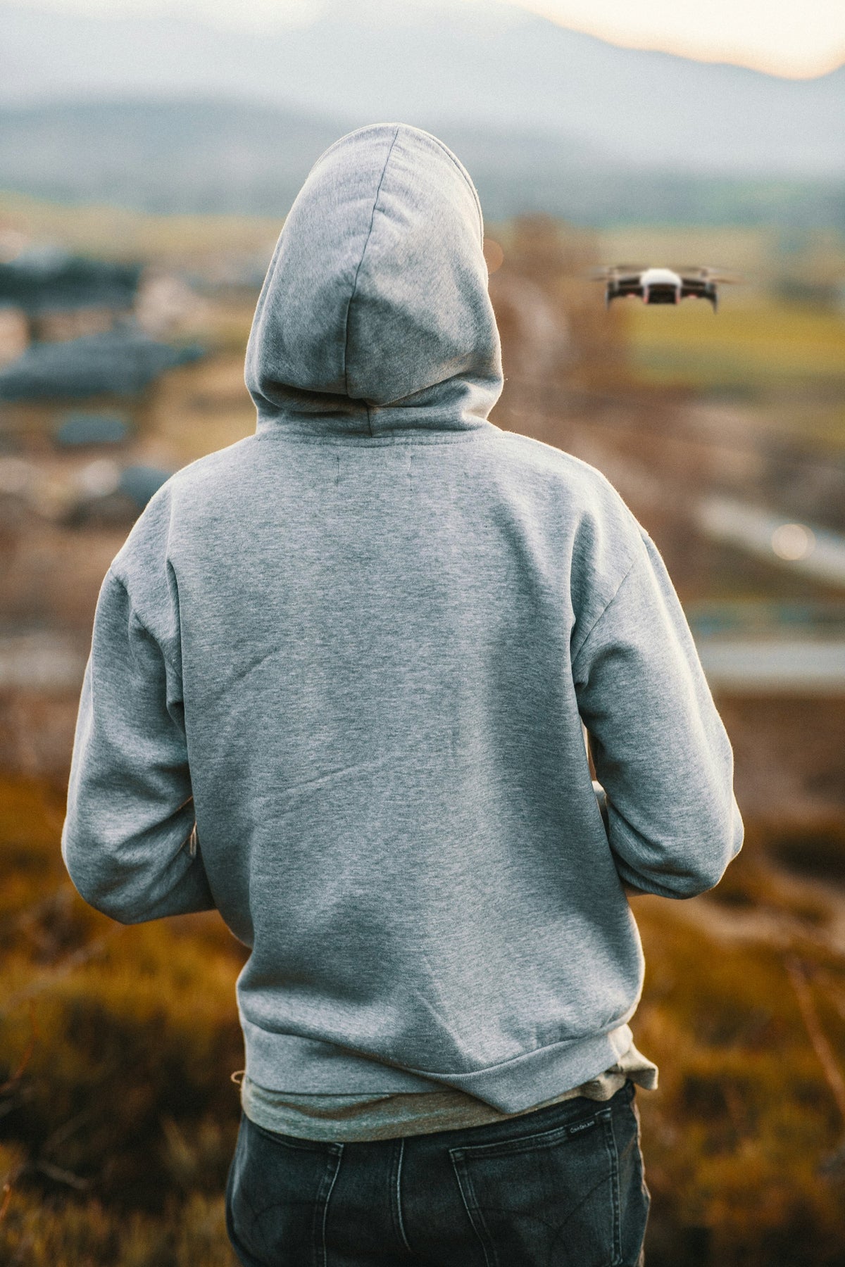 Man wearing a grey heavyweight pullover hoodie