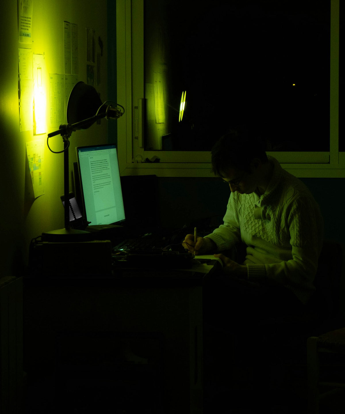 Student at laptop late at night in a cozy study space, oversized hoodie culture
