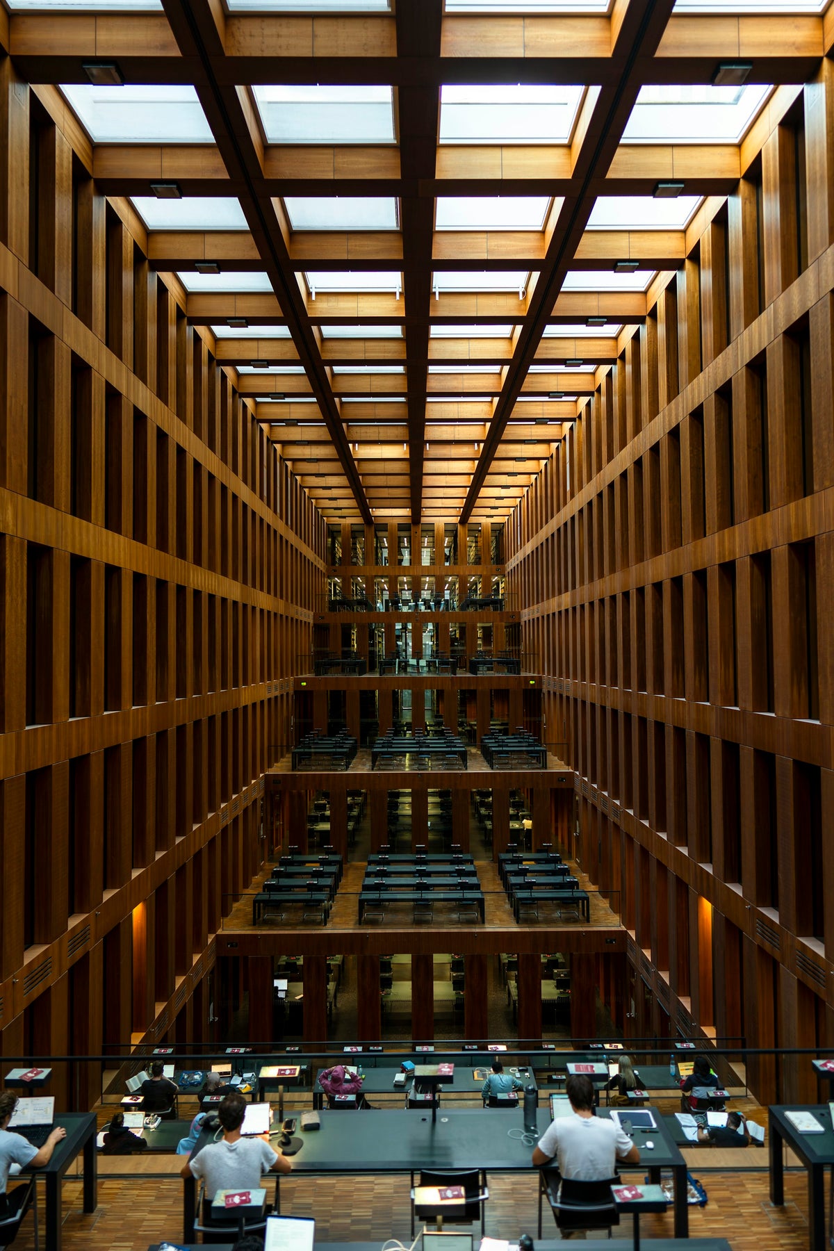Large quiet study room with warm lighting and open tables